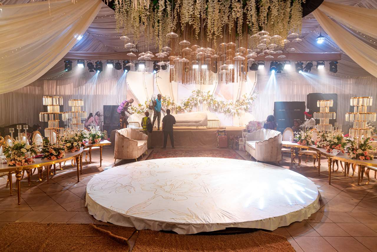 The Stadplus marquee dressed for a wedding reception, with a draped ceiling, chandeliers and a round dance floor.
